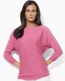 Channel modern elegance in the Jezzy sweater, rendered in a luxuriously soft blend of silk and cashmere with dramatic dolman sleeves and chic buttons at the neckline. Channel modern elegance in the Jezzy sweater, rendered in a luxuriously soft blend of silk and cashmere with dramatic dolman sleeves and chic buttons at the neckline.