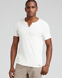 Split neck tee with eyelet details along the placket and tonal logo tab at the hem.