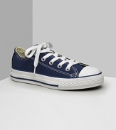 Low cut Converse All Stars. This classic canvas sneaker set the standard in cool and comfort. Available in kids sizes. With lace-up canvas uppers, contrast stitching and rubber sole and toe.