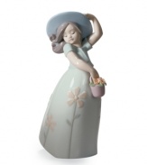 Lladro captures the innocence of youth in the Little Daisy figurine. A young lady twirls about, carrying a basket of flowers and happy to enjoy a spring day