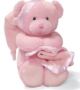 Key-wind musical bear gripping a blanket with a satin trim. Music plays Brahms Lullaby and the bear's head sways to music.
