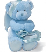 Key-wind musical bear gripping a blanket with a satin trim. Music plays Brahms Lullaby and the bear's head sways to music.