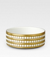A beautiful serving bowl in fine Limoges porcelain, made entirely by hand and finished with individually-applied 14k gold pearl detail. From the Perlee Gold Collection Porcelain 1¾ X 5 diam. Dishwasher safe Imported 
