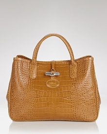 Longchamp's croc embossed leather tote exudes poise, boasting top handles and a structured silhouette. In exotic style, this bag is ready to meet daytime demands. Longchamp's croc embossed leather tote exudes poise, boasting top handles and a structured silhouette. In exotic style, this bag is ready to meet daytime demands.