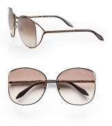 A chic metal style with intricately detailed temples and modern floating lens. Available in brown with brown gradient lens. Logo etched lens100% UV protectionMade in Italy 