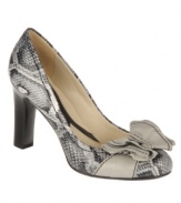 Sugar and spice. An oversized bow tops off the alluring round-toe silhouette of the comfortable Peg pumps by Naturalizer.