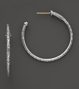 Intricately etched details dress up classic sterling silver hoops. By Konstantino.