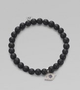 A protective symbol in many cultures, an evil eye charm of 14k white gold is richly set with diamonds and sapphires, and hangs from a stretchy strand of matte black onyx beads. Diamonds, 0.07 tcw Black onyx 14k white gold Diameter, about 2 (unstretched) Charm length, about ½ Imported