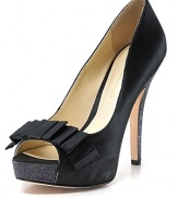 A glitter-covered platform and heel add unexpected touches to a towering peep toe pump from Enzio Angiolini, rendered in soirée-worthy satin.
