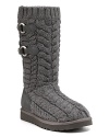 Snappy side buckles adorn these cozy cable knit boots--a stylish essential for cool days. By UGG® Australia.