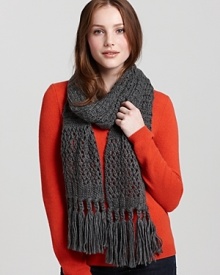 Bundle up in a thick cable knit scarf with long fringed edges. Bundle up in a thick cable knit scarf with long fringed edges.