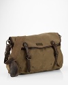 Authentic leather accents make this versatile canvas messenger bag a suitable carryall for work or weekend.