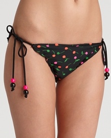 Ruffles and a cherry print sweeten this string bottom from Shoshanna. Ruffles and a cherry print sweeten this string bottom from Shoshanna.