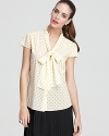 A bold polka dot print covers this quirky-cool Alice + Olivia tie-neck blouse. Style with a pleated skirt and pumps for a modern take on preppy chic.