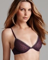 A lace overlay lends allure to this underwire bra from Calvin Klein. Style #F3535