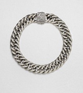 A signature link design of smooth, shiny sterling silver with wave design detail on the clasp.Sterling silverAbout 2 diam.Imported