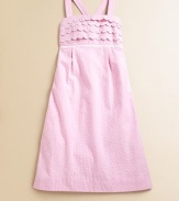 Crafted in preppy seersucker, this classic A-line frock is ultra-glam with scalloped detail, lace trim and smocked back.SquareneckAdjustable straps cross at backScalloped bodicePleated empire waistCottonMachine washImported
