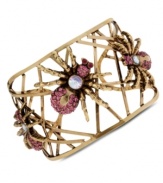 Fashion with legs. Betsey Johnson's cuff bracelet weaves a stylish web with pink and clear crystal-accented spiders. Crafted in antiqued gold tone mixed metal. Approximate diameter: 2-3/8 inches.