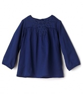Add some bohemian flair with a macramé-detailed blouse from Pearls & Popcorn.