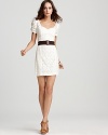 Fashioned in delicate lace, this GUESS dress comes with a thick elastic belt for an edgy contrast.