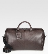 An elegant and efficient travel companion, spacious enough to carry all of your essentials in style, crafted in woven Italian leather.Zip closureTop handlesRemovable shoulder strapInterior zip pocketLeather22W x 14H x 9DMade in Italy