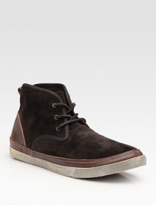 Rich suede construction trimmed in leather and tied together with leather laces. Padded insole Rubber sole Imported 