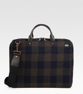 A lightly padded laptop case designed in rugged plaid-check wool with leather handles. Zip closure16L X 12H X 3DImported