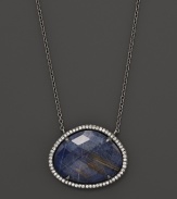 Diamonds circle a faceted rutilated quartz and blue sodalite doublet set in blackened sterling silver. By Di Massima.