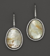 Diamonds circle a faceted doublet of rutilated quartz over mother of pearl, set in blackened sterling silver. By Di Massima.