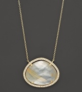 Diamonds circle a faceted rutilated quartz and mother-of-pearl doublet set in 18K yellow gold. By Di Massima.