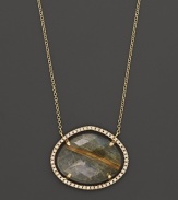 Diamonds circle a faceted rutilated quartz and smoky labradorite doublet set in 18K yellow gold. By Di Massima.
