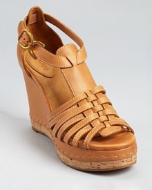 These leather Chloé sandals exude faint vintage appeal, with an interwoven design and cork accents on a tall platform silhouette. These leather Chloé sandals exude faint vintage appeal, with an interwoven design and cork accents on a tall platform silhouette.