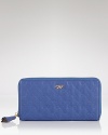 Being practical has never been cooler. Boasting textured leather and a cool hue, Anya Hindmarch's zip around wallet is an enviable essential.