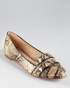 Loeffler Randall updates a classic penny loafer silhouette, dressing it up with of-the-moment details--a snakeskin print, feminine shape and glossy patent trim make the Babette loafer a must-have.