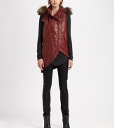 From the HELMUT capsule collection. Chic puffer vest has a raccoon fur-trimmed hood and trendy asymmetrical hem. Attached hood with dyed raccoon fur trimSleevelessFront zipperSlash pocketsAsymmetrical hemAbout 31 from shoulder to hem85% nylon/15% polyurethaneDry cleanImported of Italian fabricFur origin: FinlandModel shown is 5'10 (177cm) wearing US size Small.