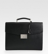 Signature, structured briefcase style of textured saffiano leather.Top handle, 1½ dropFlap, push lock closureInterior open, zip pocketsLeather15W x 11H x 2DMade in Italy