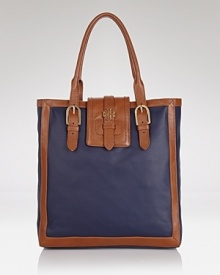 Upgrade your day bag with this coated canvas tote from Tory Burch. A simple yet spacious design and buckled detailing make this practical style an ever-chic choice. Upgrade your day bag with this coated canvas tote from Tory Burch. A simple yet spacious design and buckled detailing make this practical style an ever-chic choice.