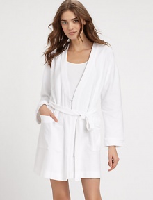 Wrap yourself in this waffled cotton piqué design, with elasticized waistband and long sleeves for superior fit and comfort. V-neckLong sleevesTrim piping at the neckline and cuffsElasticized waistband with attached self-tie beltDual front patch pocketsAbout 35½ from shoulder to hemCottonMachine washImported Wrap yourself in this waffled cotton piqué design, with elasticized waistband and long sleeves for superior fit and comfort. V-neckLong sleevesTrim piping at the neckline and cuffsElasticized waistband with attached self-tie beltDual front patch pocketsAbout 35½ from shoulder to hemCottonMachine washImported