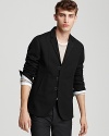 Cool updates put a modern edge to this slim fit blazer: hook and bar front closure, patterned lining and narrow notch lapel.