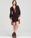 This Free People dress plays up the season's hippie mood, flaunting florals on a loose-fitting silhouette designed with bell sleeves and a of-the-moment high/low hem.