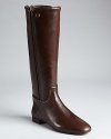 Tory Burch gives a sleek, timeless riding boot the Midas touch, with subtle signature goldtone accents.