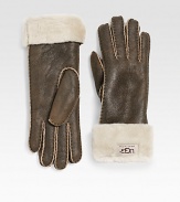 Classic cuffed style in supple leather with luxuriously warm shearling lining. Front logo tab detail About 11 long Dry clean by leather specialist Imported Fur origin: Spain