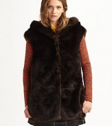 Top off any ensemble with a hint of plush in this shimmering faux fur vest with a cold-conquering hood and convenient snap closures. Attached hoodSnap closuresFully linedAbout 29 from shoulder to hem87% modacrylic/13% polyesterDry cleanMade in USA of Italian fabricModel shown is 5'10 (177cm) wearing US size 2.