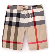In an allover check print, these iconic swim trunks from Burberry take classic style to the seaside.