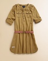 Cute, cargo-inspired frock with a bold printed belt is the perfect mix of utility and girlie style.CrewneckLong sleeves with button tab for adjustable lengthFront button placketShoulder epauletsButton flap-bellows pocketsRemovable elasticized printed belt at waistEven rounded hem with side ventsCottonMachine washImported Please note: Number of buttons may vary depending on size ordered. 