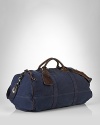 Ideal for travel, a rugged canvas duffle gets a luxe update from rich leather handles.Full-zip top closure.