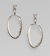 From the Kali Collection. A free-formed, open oval drop with a pebbled interior in sleek sterling silver. Sterling silverLength, about ¾Post backImported 