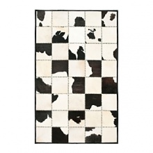 The bold black and white cowhide patchwork motif on this Ralph Lauren rug warms your living space with a sleek interpretation of Western style. The bold black and white cowhide patchwork motif on this Ralph Lauren rug warms your living space with a sleek interpretation of Western style.