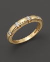 Diamonds dot a 14K yellow gold band.