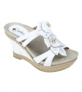 A bouquet of beauty. Nature-inspired embellishments top off the leather straps of the lovely Semprini sandals by Earthies. Espadrille trim finishes off the slim wedge heel.